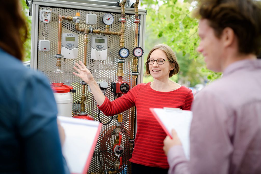 Teacher explaining students the solar thermal system