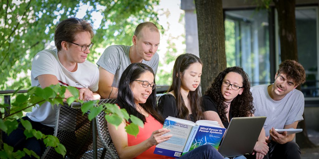 Group of students reading a book