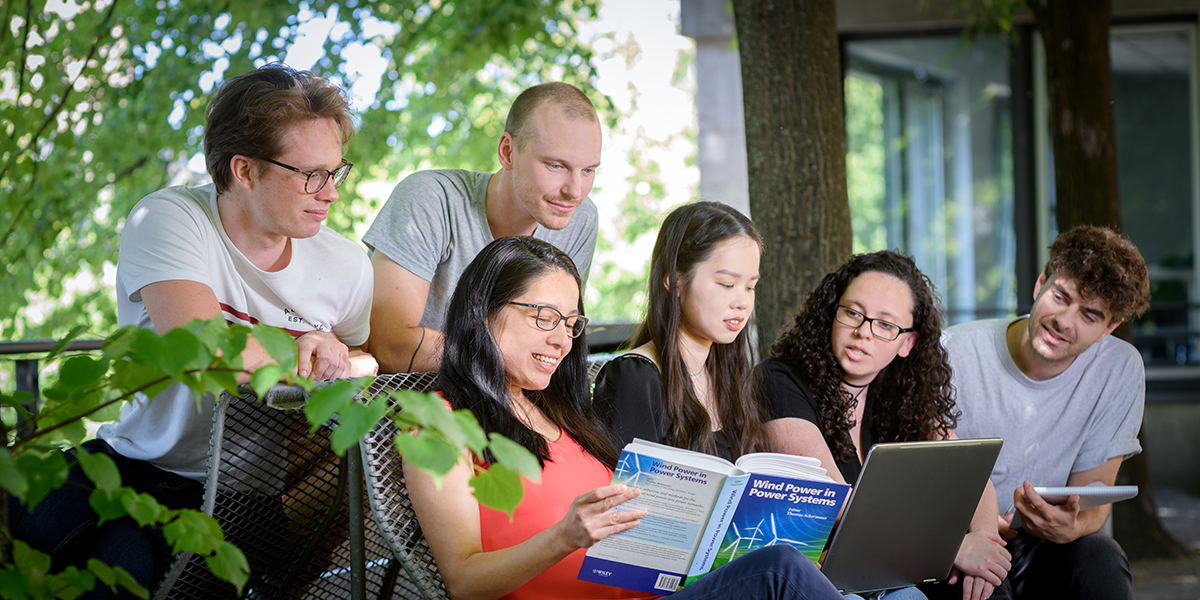 Group of students reading a book