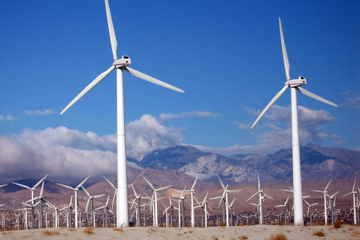 Wind turbines infront of mountains