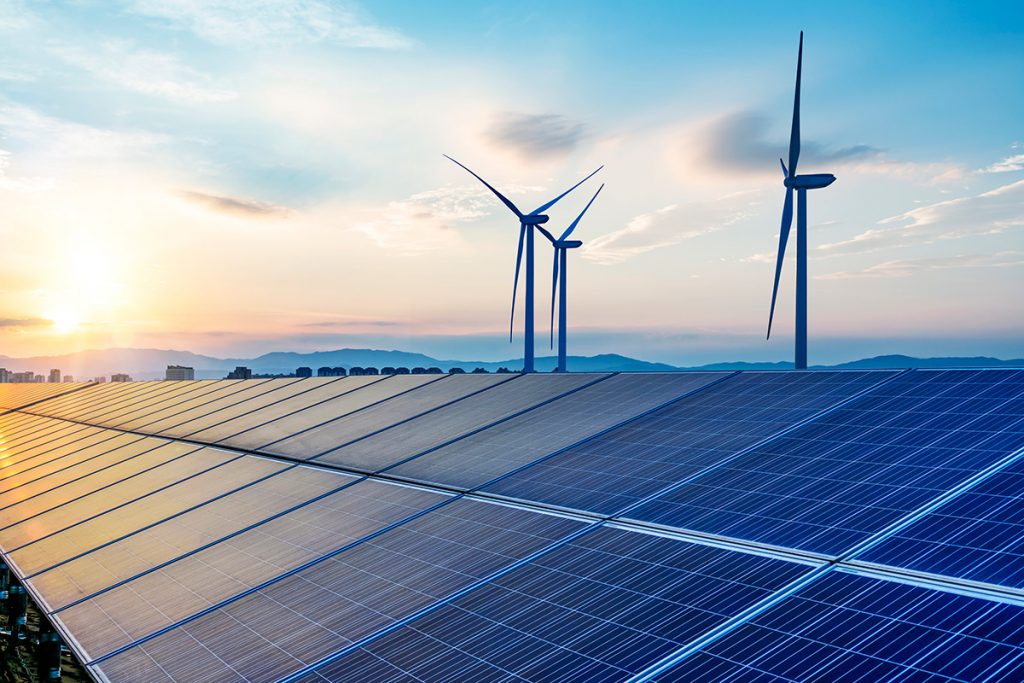 Solar energy- panels and wind mills in the sunset