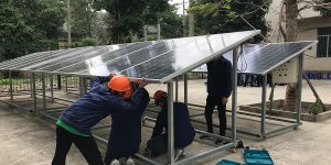 Workers fixing a solar panel.