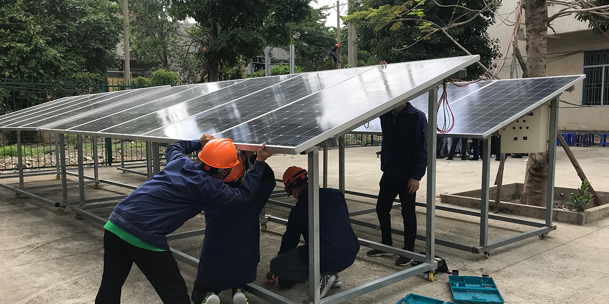 Workers fixing a solar panel