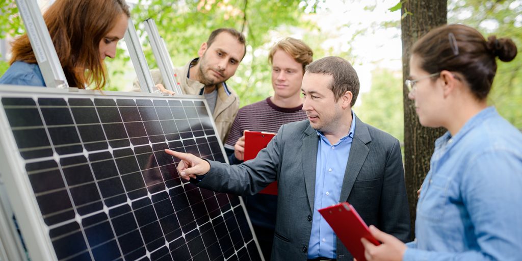 Teacher explaining structure of solar panel