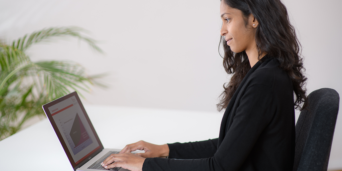 Woman writing in a laptop